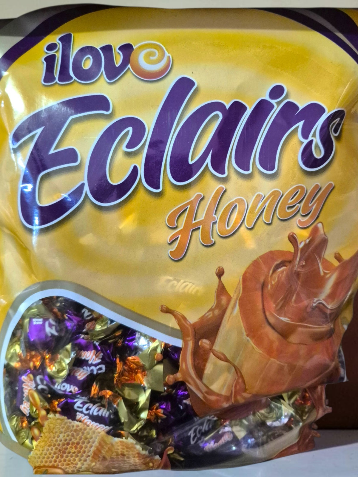 SY DISCOUNT WAREHOUSE I Love Eclairs Honey toffees in an 800g bag with purple and gold individual wrappers